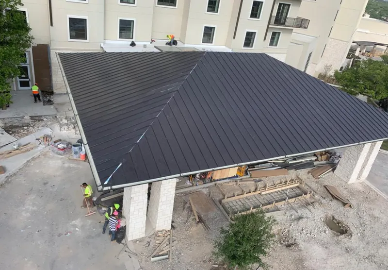Metal roofing installation team working on a commercial building in Buckhall